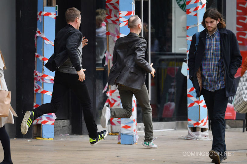 EDINBURGH, SCOTLAND - JULY 13:  Actors Ewan McGregor and Ewan Bremner run on the set of the Trainspotting film sequel on Princess Street on July 13, 2016 in Edinburgh, Scotland. The long awaited Trainspotting 2 is being filmed in Edinburgh and Glasgow, 20 years after the original was released and it will also see the cast from the first film returning including Ewan McGregor, Jonny Lee Miller and Robert Carlyle.  (Photo by Jeff J Mitchell/Getty Images)